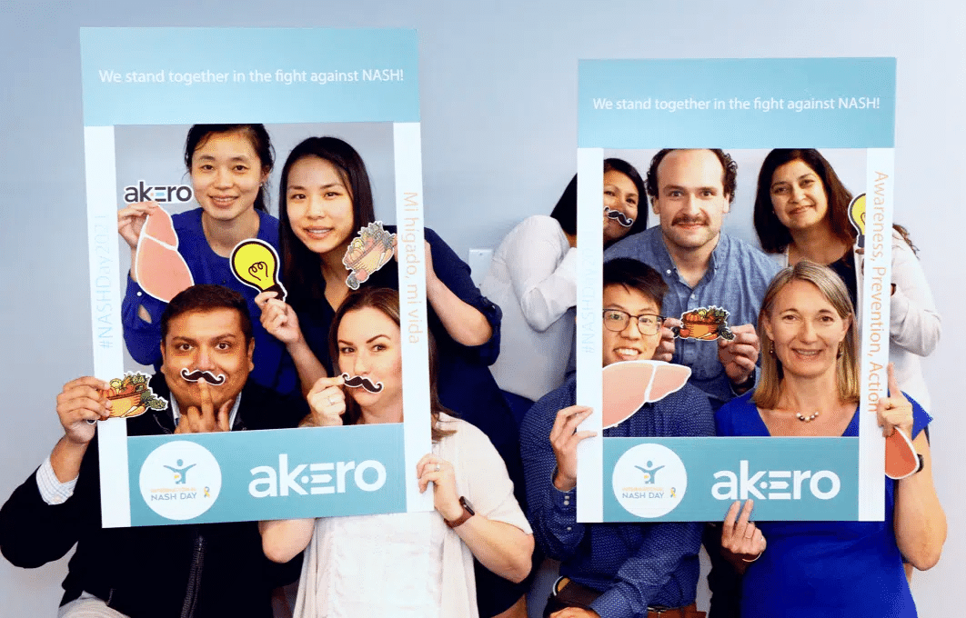 Akero team posing with photo booth props at an event for Global Fatty Liver Day